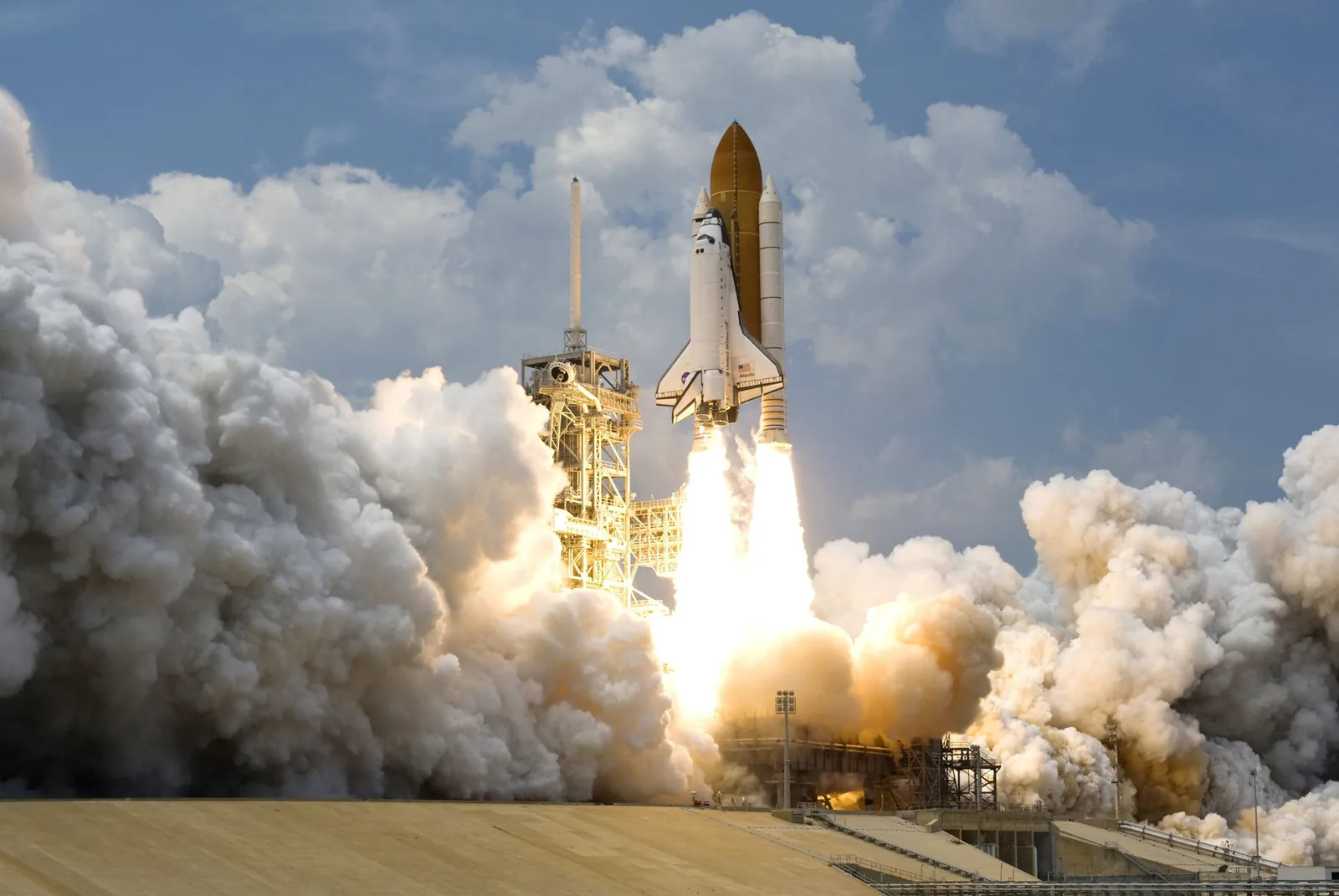 Space shuttle lifting off from the launch pad